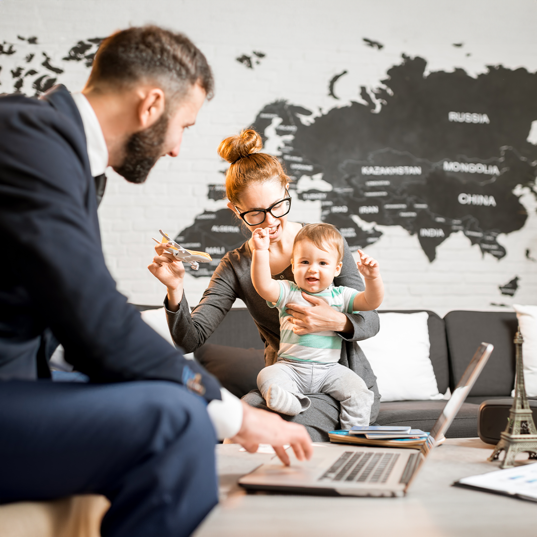 A working family working in an office setting with their baby included.