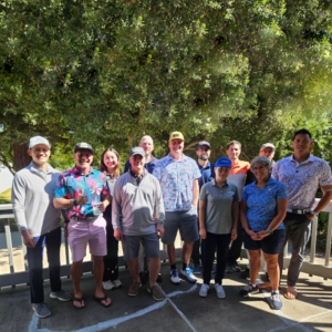 Withum team members smiling during the 12th annual golf tournament.