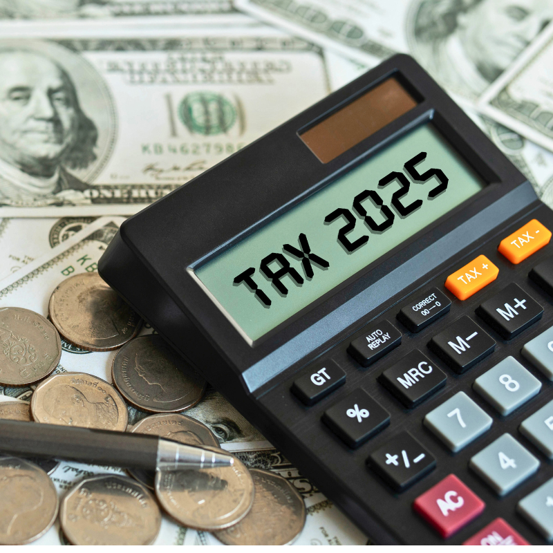 Tax 2025. Word Tax 2025 on calculator. Business and tax concept. Calculator, currency, dollar bills close up