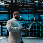 Data center software developer using laptop to audit systems.